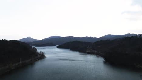 aerial drone shot of beautiful cinematic south korean river and forest in nature