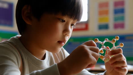 young boy studying chemistry in school