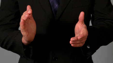 businessman in suit clapping hands