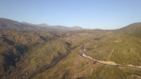 drone flying high over mountain pass road