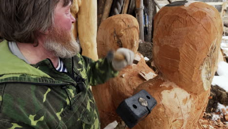 wood carver working on sculptures