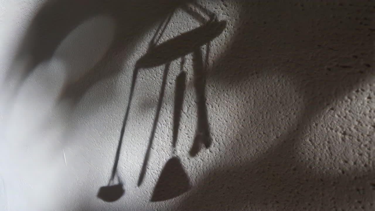 Dynamic Shadows of a Wind Chime on a Textured Wall