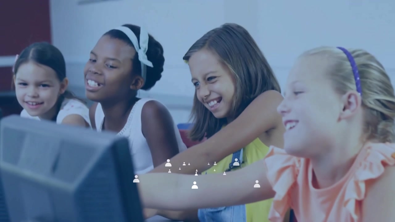 Student girls pointing at computer screen and tapping keyboard sharing excitement in education lab