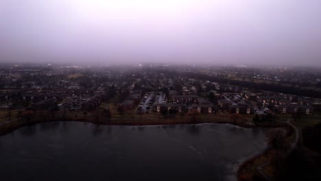 aerial-of-vernon-hills-residential-houses-located-next-to-century-park-sledding-hill-at-blue-hour---twilight-sorounded-by-mist