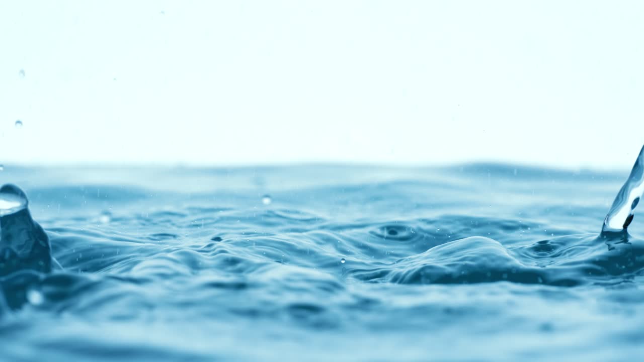 Rain water drops falling in super slow motion.