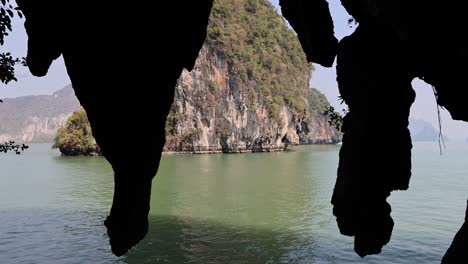 boat glides through a natural cave entrance