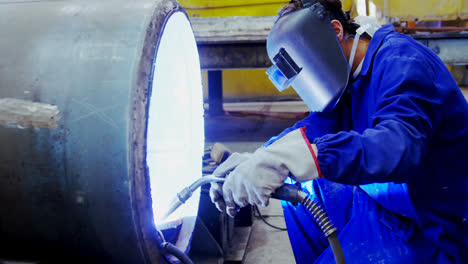 male engineer using welding torch 4k