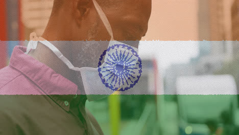 Composition-of-man-wearing-face-mask-over-indian-flag