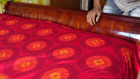 making a bed with patterned bedsheet