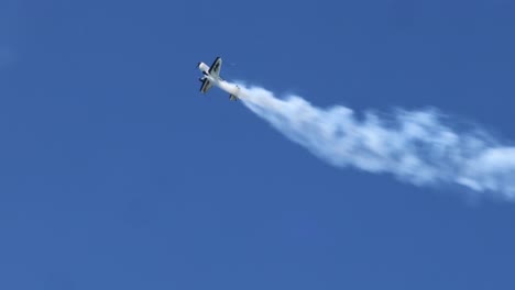 planes execute complex maneuvers with smoke trails