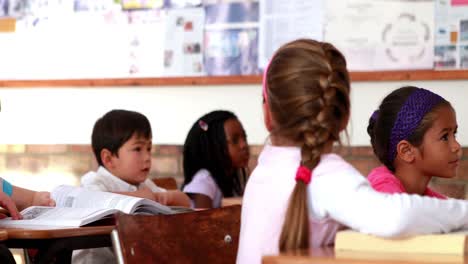 Cute-pupils-listening-attentively-in-classroom