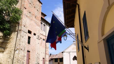 european and italian flags waving in the breeze