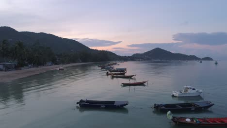 tranquil sunset over a tropical beach with boats