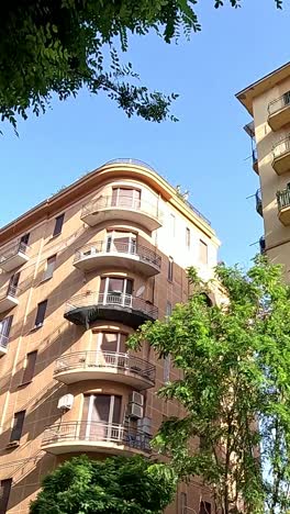 apartments with trees under a clear blue sky