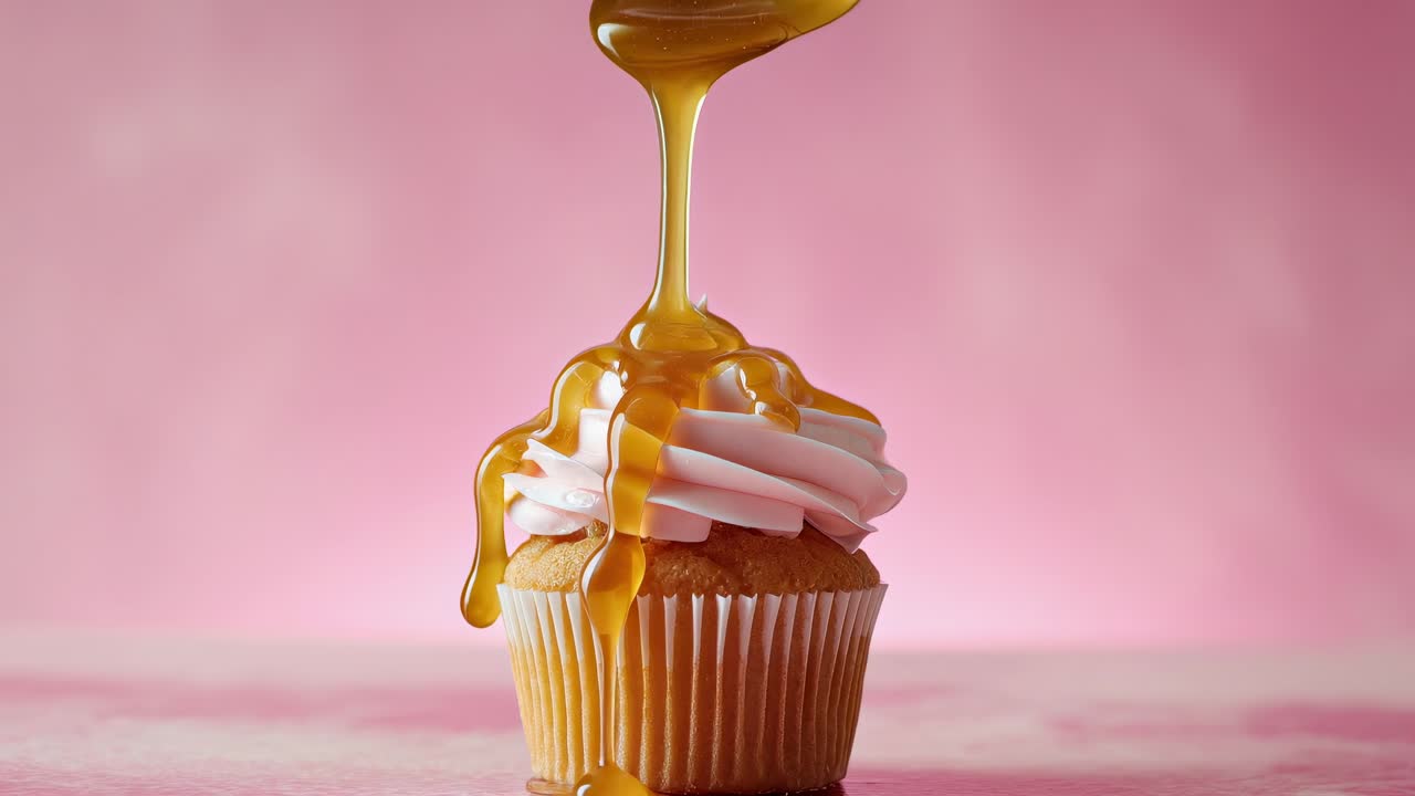 Indulge in a delicious cupcake adorned with a sweet caramel drizzle for pure delight