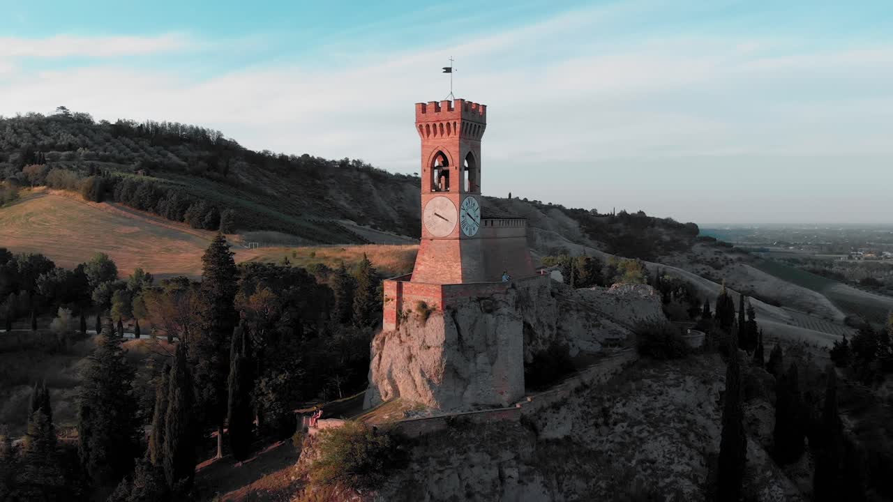 Drone flyby at sunset of the medieval clock tower. Brisighella, Emilia Romagna, Italy.