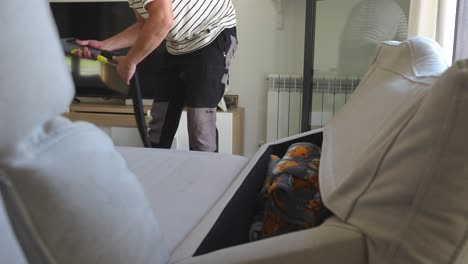 freelance worker offering a home service cleaning the sofa with special tools and machines to protect the fabric and disinfect it of germs