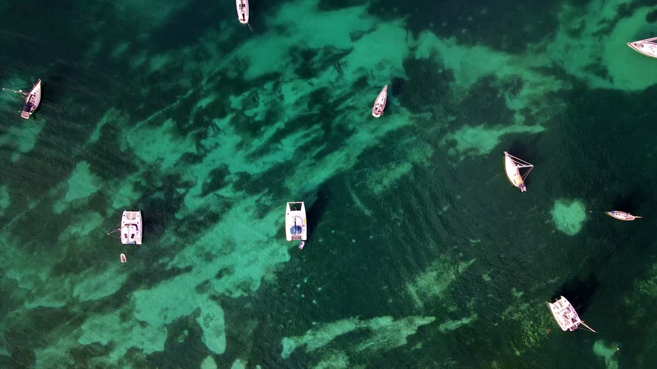 Sailing yachts at anchor off the island of Antigua in the Caribbean