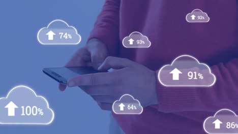 animation of cloud symbols uploading data over midsection of caucasian man using smartphone