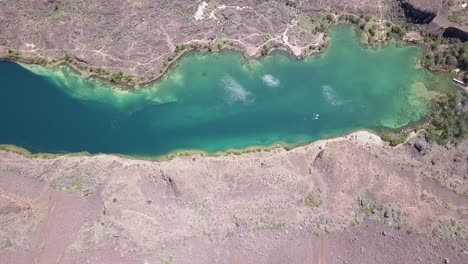 Sunshine-reflects-off-surface-of-clear-green-water-of-Deep-Lake,-WA