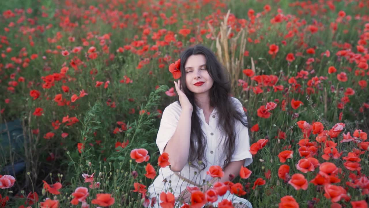 A woman enjoying a moment in a vibrant poppy field