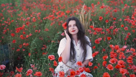 a woman enjoying a moment in a vibrant poppy field