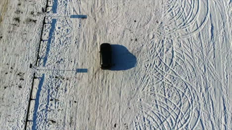 drone shot of ice roads in estonia during the winter snow with blue sky's