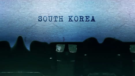 south korea word closeup being typing and centered on a sheet of paper on old vintage typewriter
