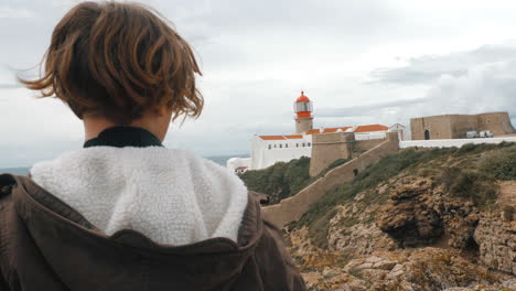 Child-tourist-taking-pictures-of-Cape-St-Vincent-Lighthouse-Portugal