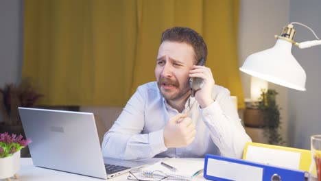home office worker man getting bad news on the phone.