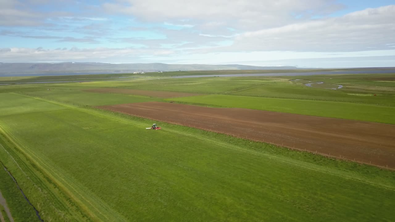 Aerial view of Icelandic farmlands with tractor