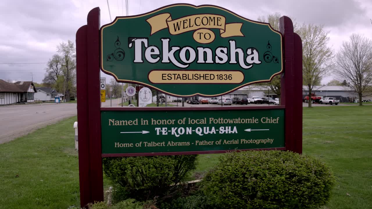 Welcome to Tekonsha, Michigan sign with gimbal video walking forward