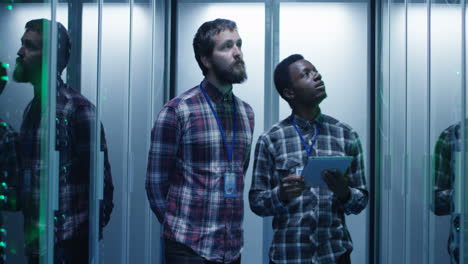 it engineers inspecting servers in a data center