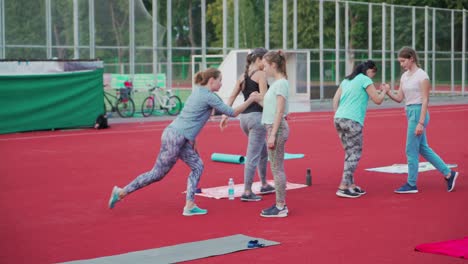 group outdoors sport training. girls doing exercises on the outdoor stadium