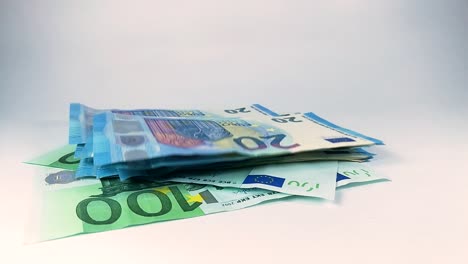 bunch of twenty euro banknotes falling down on two one hundred notes, still