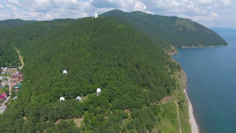 aerial view of mountainous landscape with lake and observatory