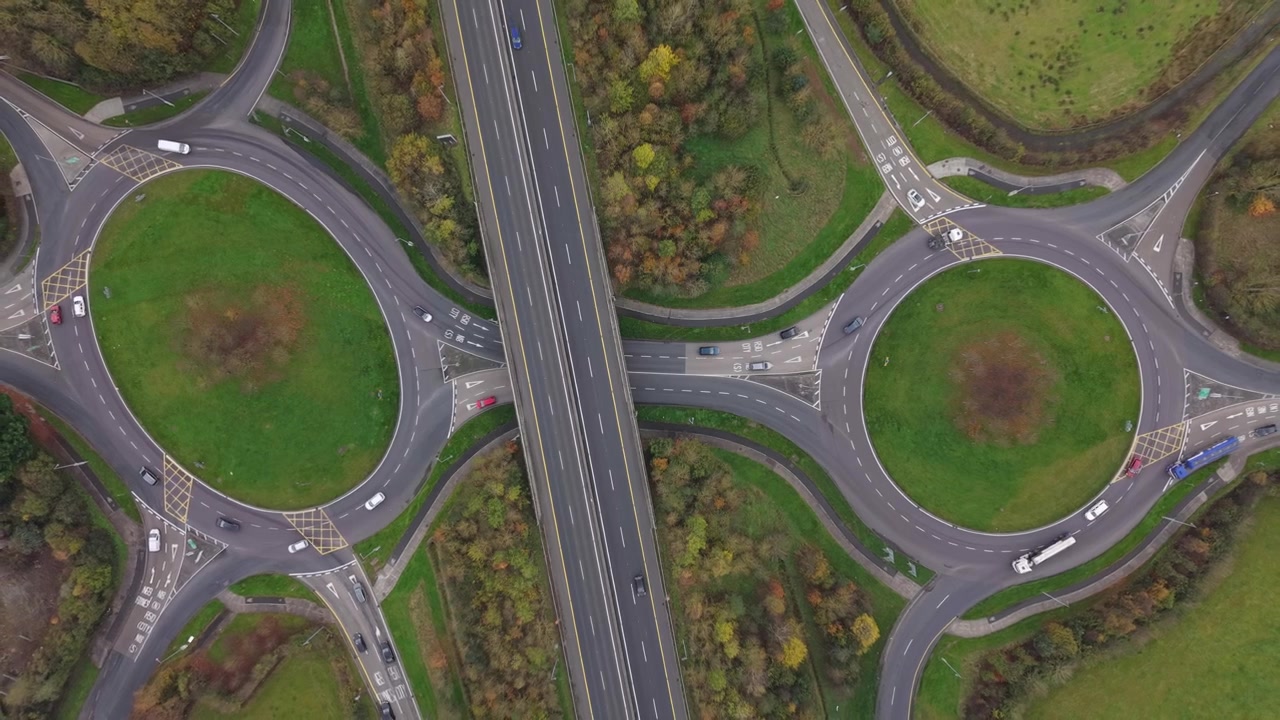 Overhead View Of Cars Driving On The Roundabouts And N18 Road In Limerick, Ireland. - aerial ascend shot