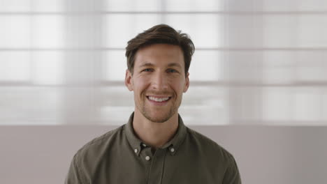 close-up-portrait-of-handsome-young-man-turns-head-smiling-happy-looking-at-camera