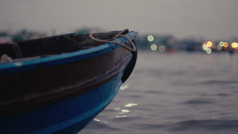 small blue boat at night