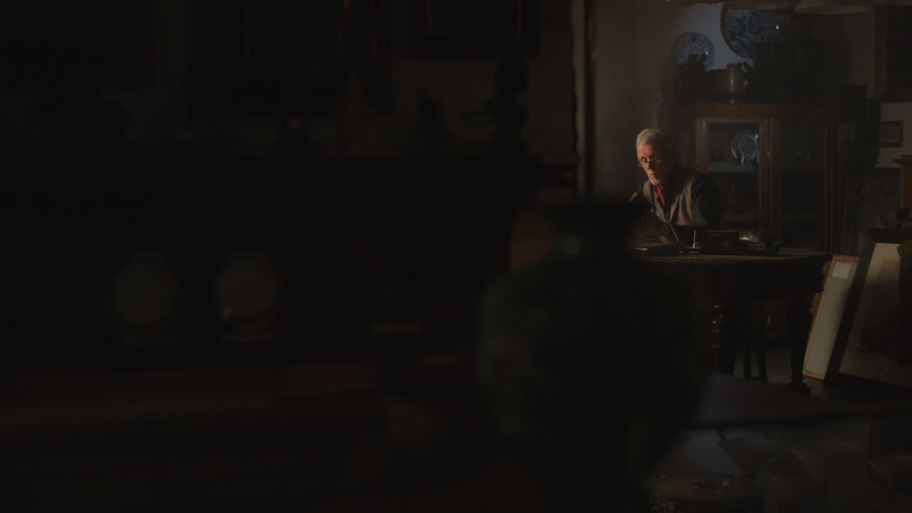 Old passionate man read a book in his office at night