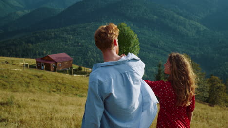 lovely millennials hold hands on mountains walk. young couple enjoy vacation.