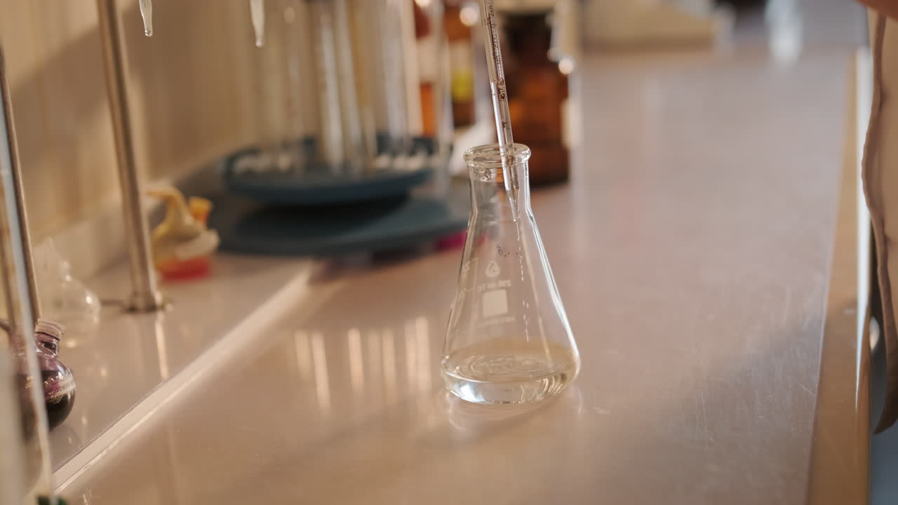 Chemistry lab experiment with flask and pipette