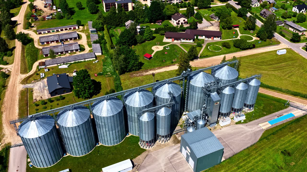 Aerial view of agricultural grain silos in rural town on sunny summer day