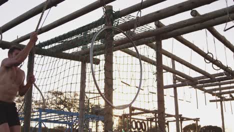 young man training at an outdoor gym bootcamp