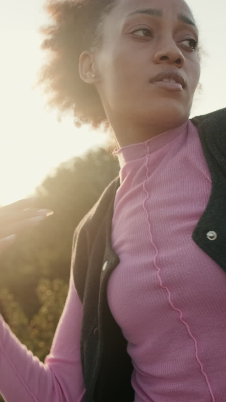 Young Woman Dances on Rooftop at Sunset