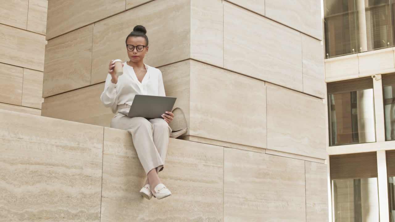 Contemporary Businesswoman Working on Laptop Outdoors