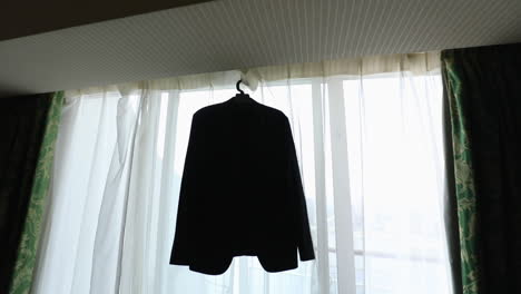 Groom's-suit-hanging-on-the-window-in-the-morning---push-out