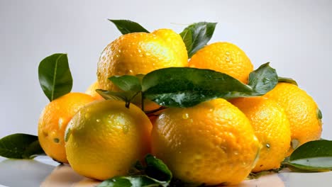 fresh yellow lemons with green leaves arranged on a light background