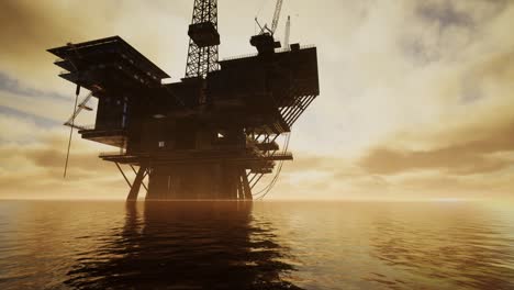 offshore jack up rig in the middle of the sea at sunset time