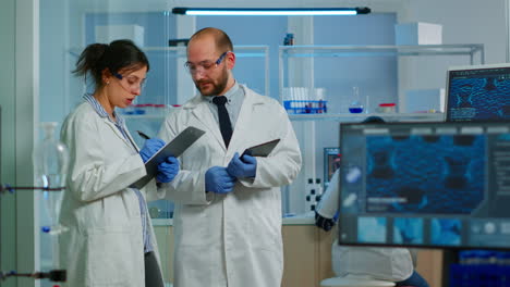 scientists coworkers using digital tablet working in medical research laboratory